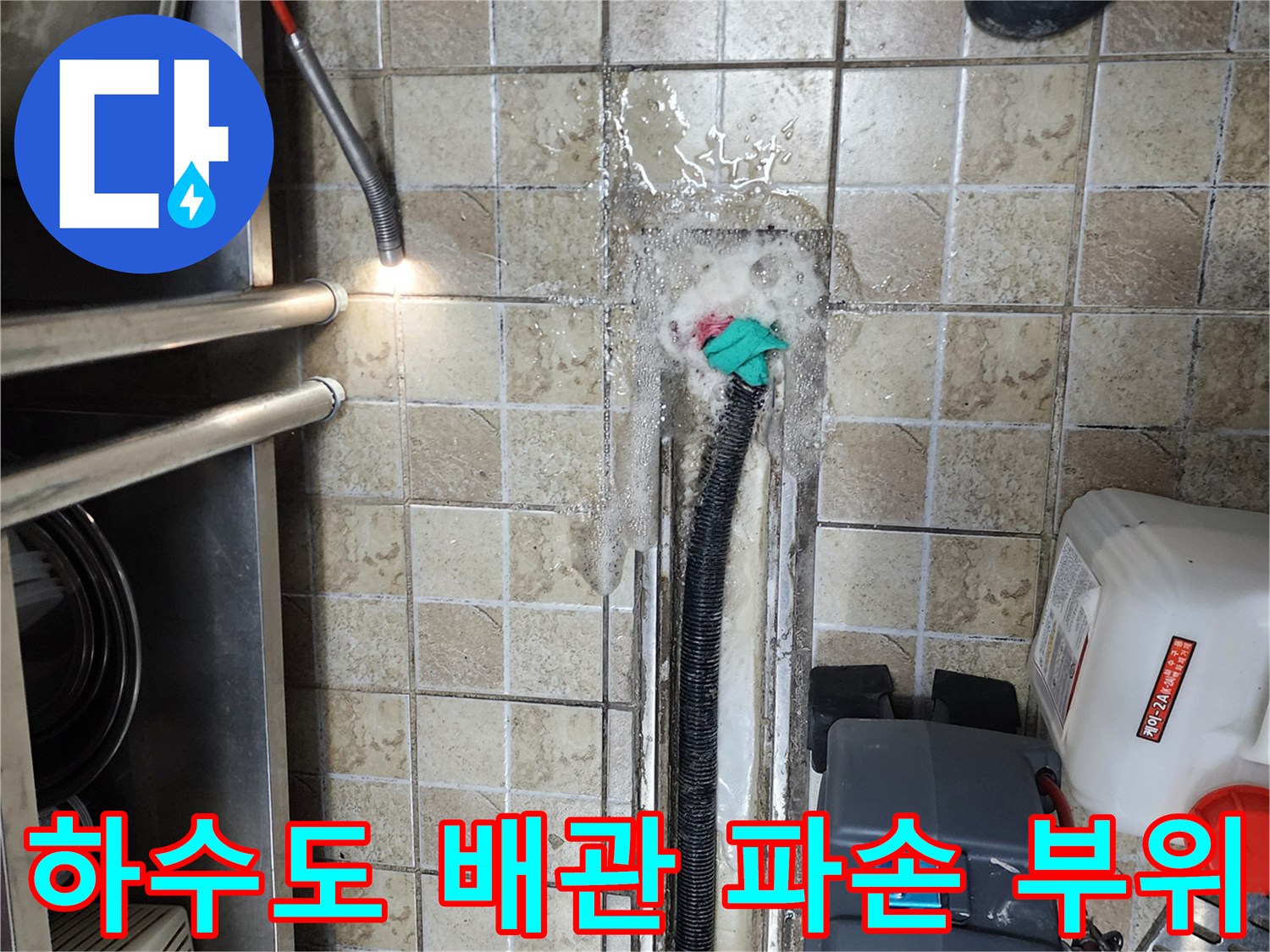 하패리 상가 주방-검은색 배관 연결부에서 누수가 발생하는 장면