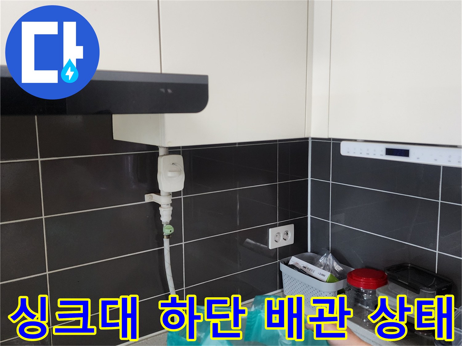 주방 싱크대 하부장 아래 설치된 급수 배관과 연결 부위 모습