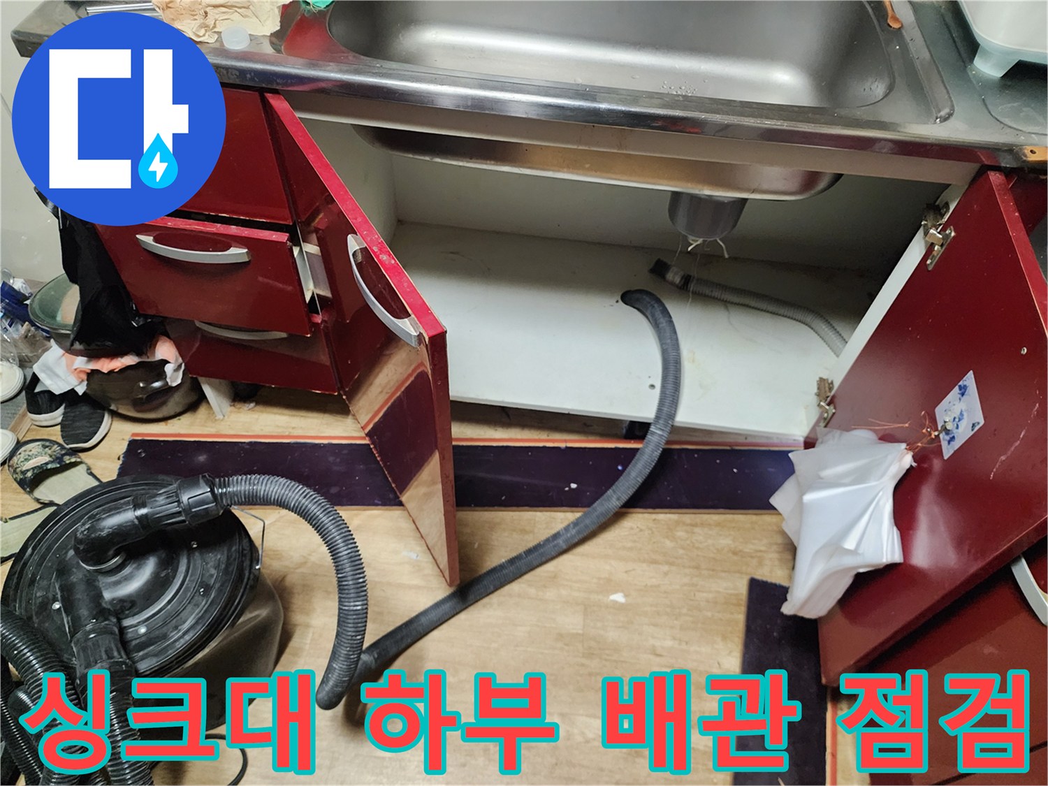 주방 싱크대 아래쪽의 배수 호스 및 주변 환경 촬영