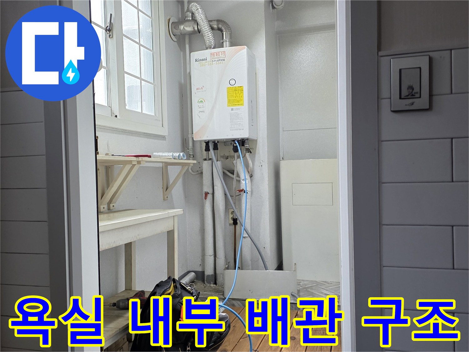 욕실 벽면 하단에 위치한-온수 분배기와 각종 연결 배관들