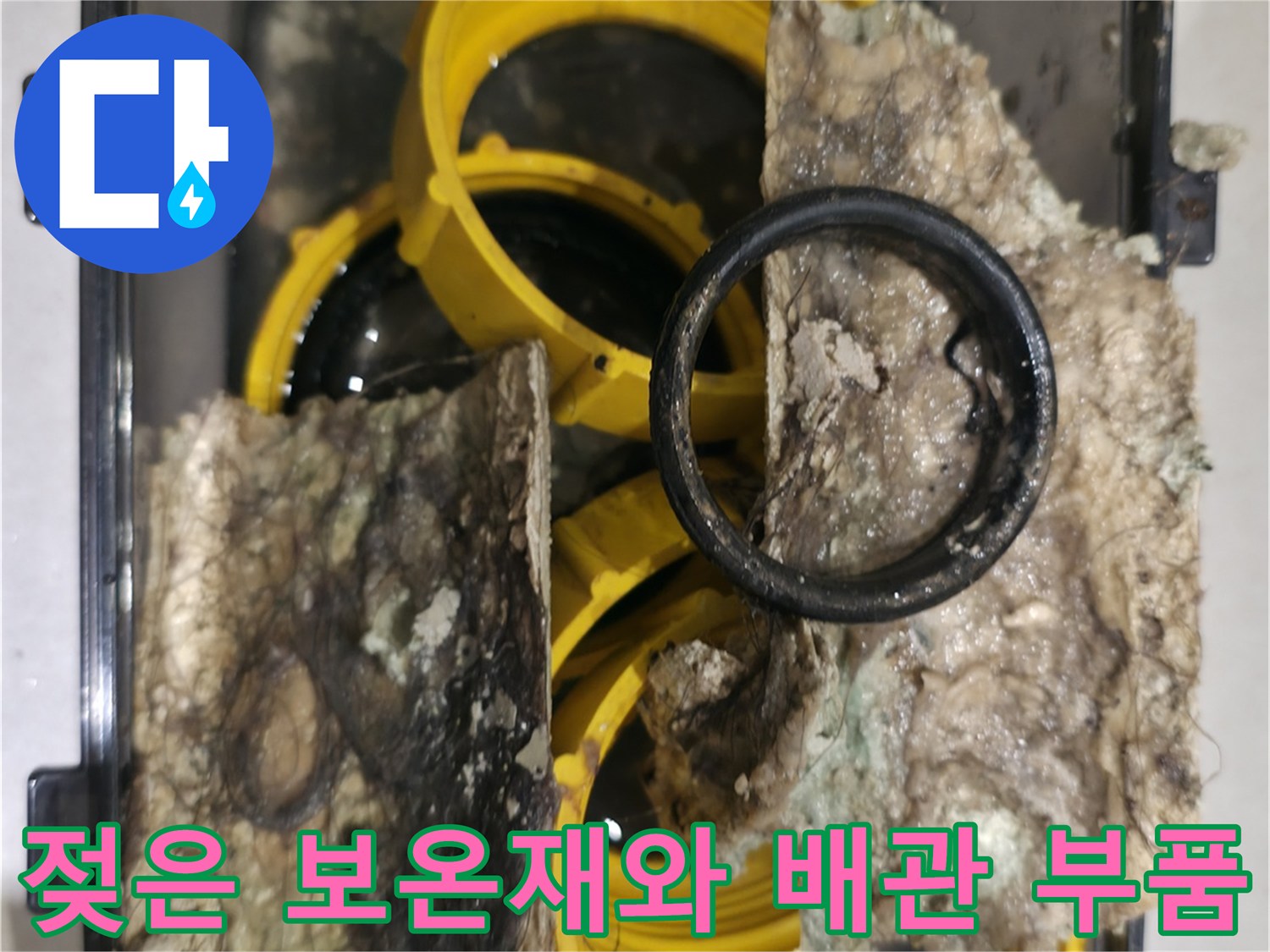 누수로 인해 눅눅해진 보온재와 노란색 배관 연결 부위