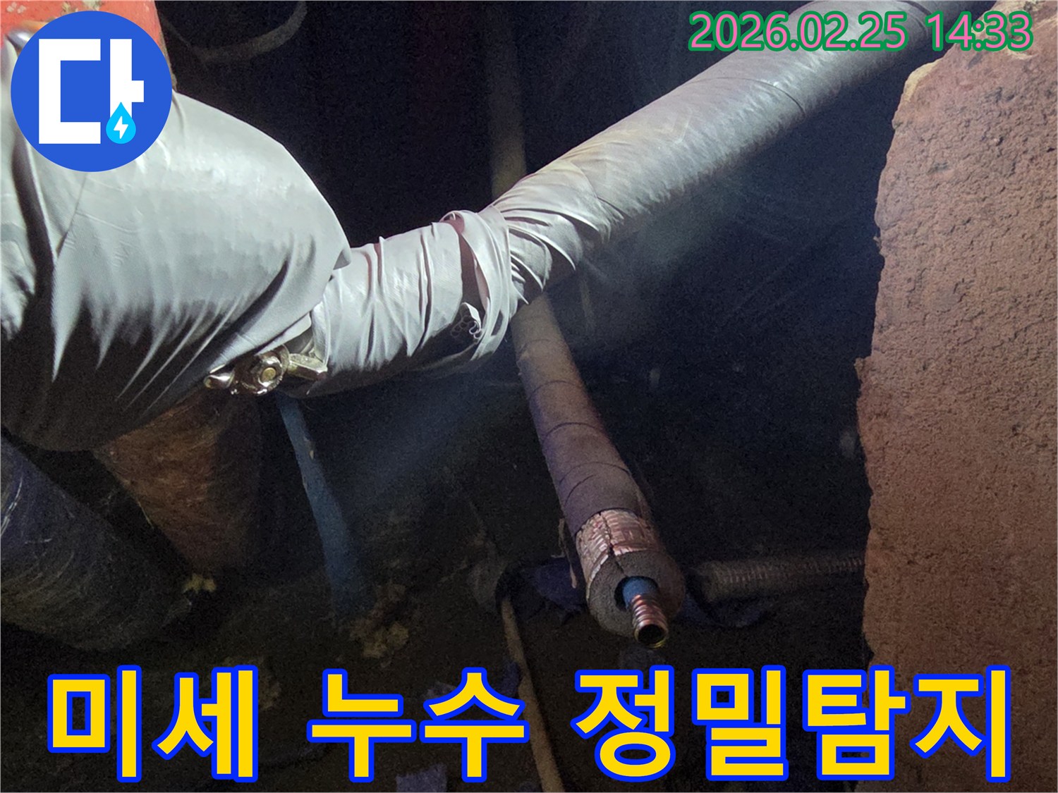 어두운 작업 공간에서-장갑을 낀 손이-최첨단 탐지 장비를-활용하여-배관의 미세한 누수 지점을-정확하게 찾아내는-모습입니다