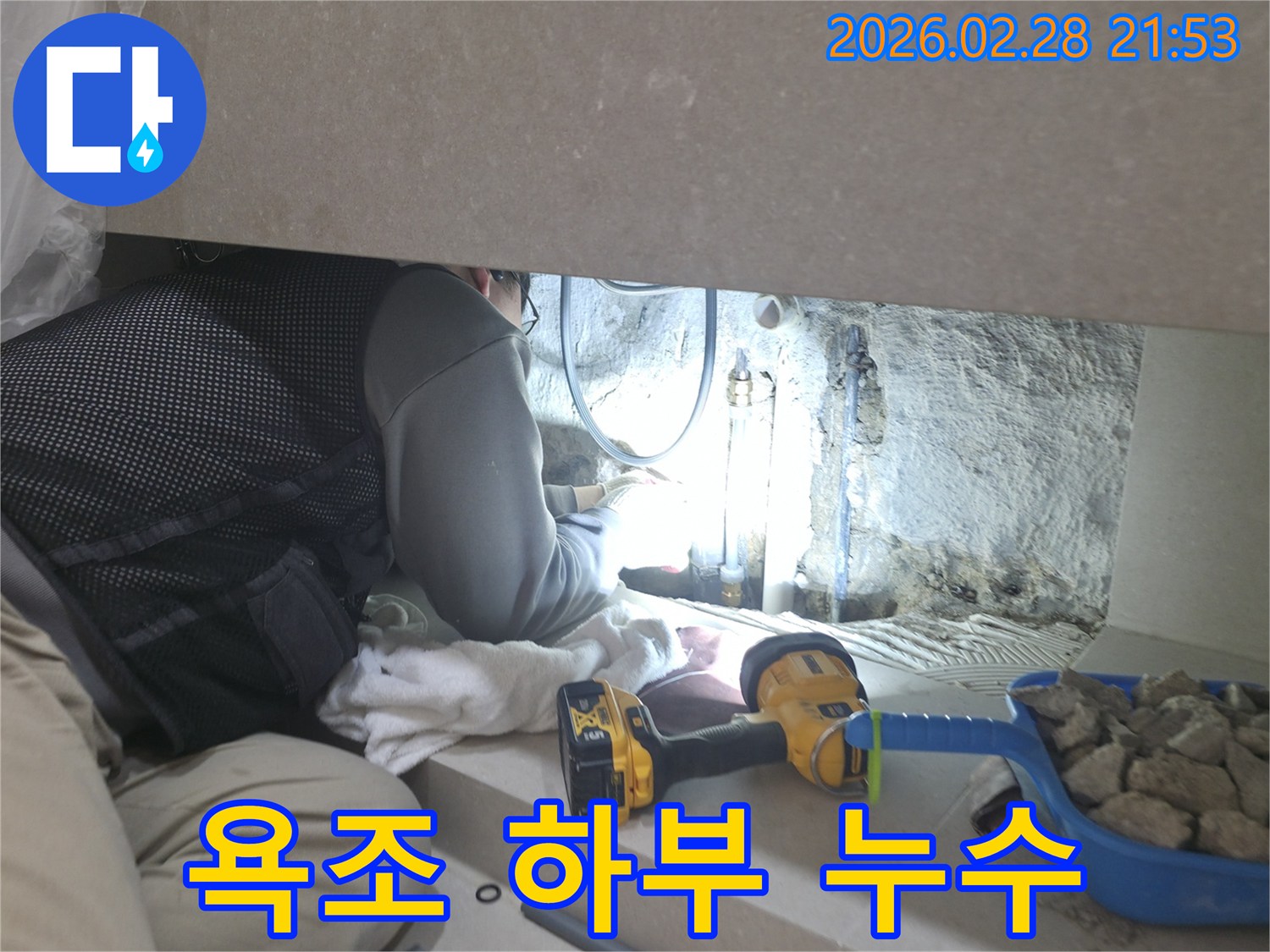 욕조 하부의-좁은 공간에서-누수 지점을-정확히 찾아내기 위해-집중하여-작업하는-전문가의 모습입니다.