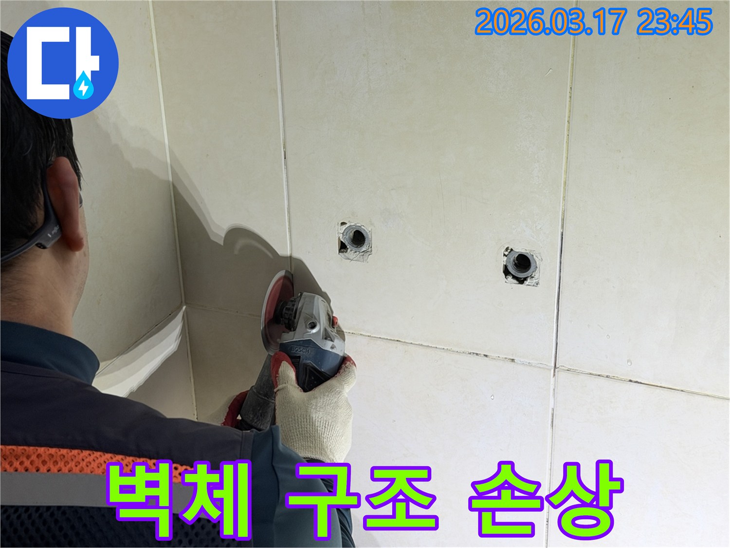 누수 엔지니어가-주택 누수로 인한 벽체 구조 손상을 확인하기 위해-벽면 타일을 정밀하게 절단하는 모습