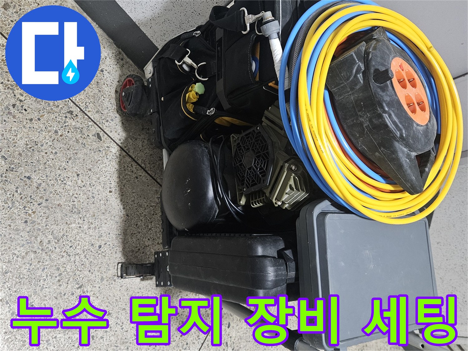 누수 현장 점검을 위해 준비된 전동 드릴과 릴선 및 공구 가방