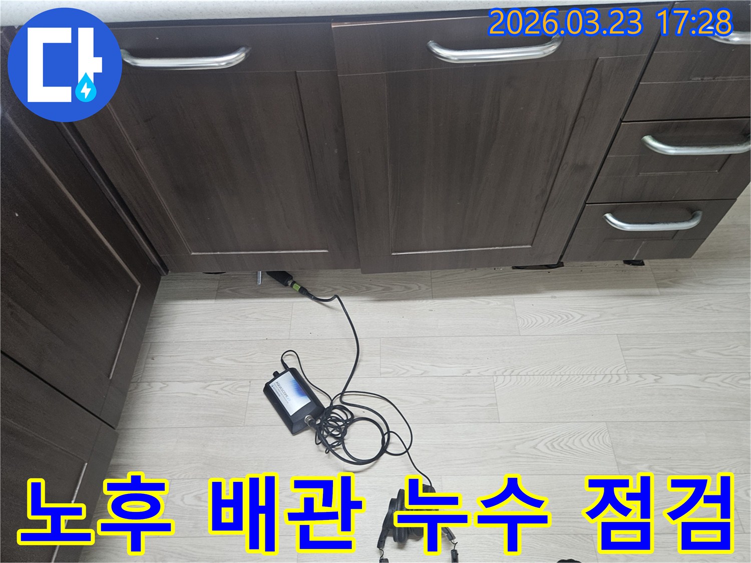 용인 주방 싱크대 아래-노후된 배관에서 발생할 수 있는-누수를 사전에 점검하기 위해-전문 장비를 사용하는 모습