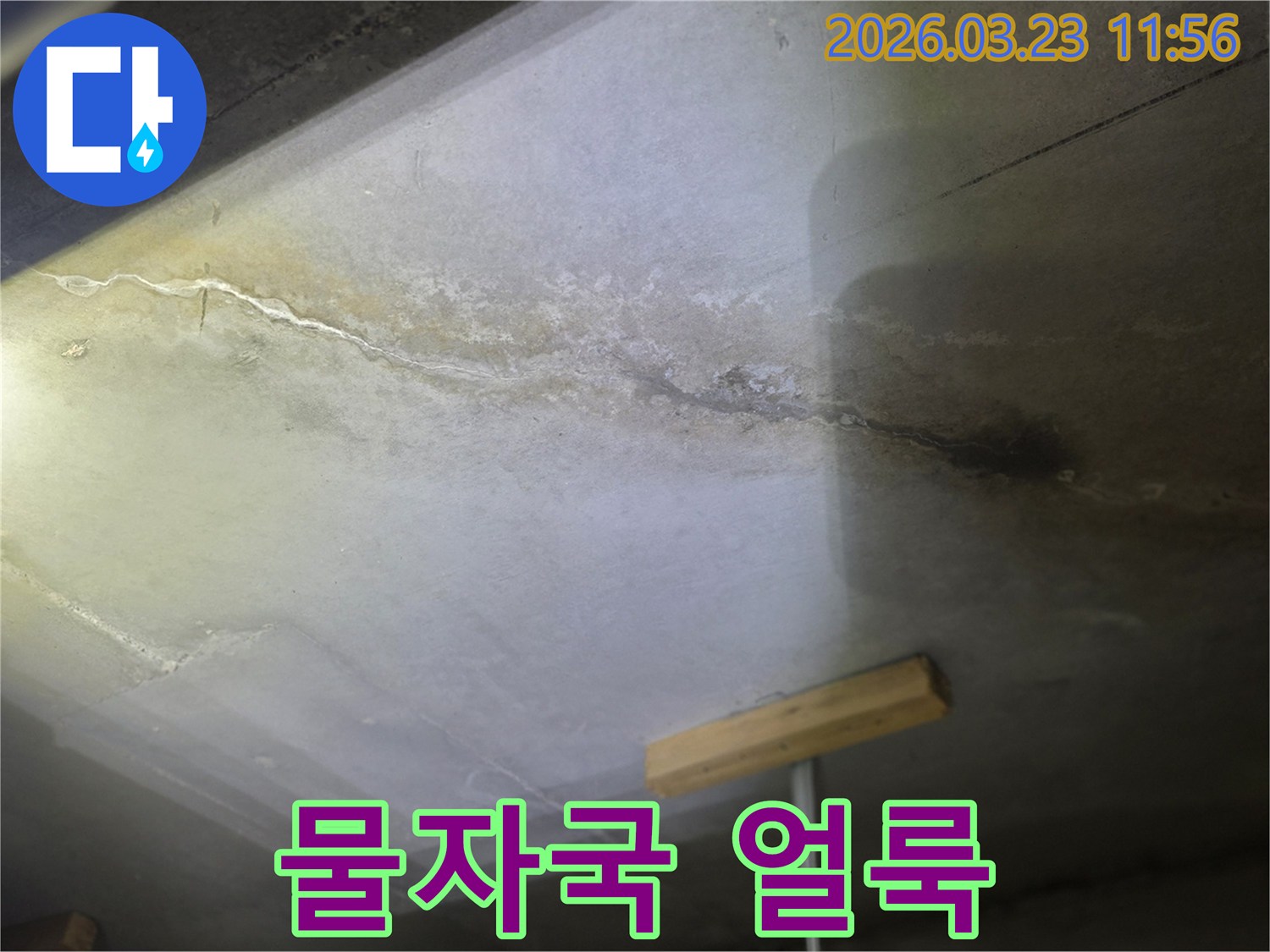 천장 콘크리트에 생긴 물자국과-오래된 누수로 인한-얼룩을 보여주는 사진입니다.