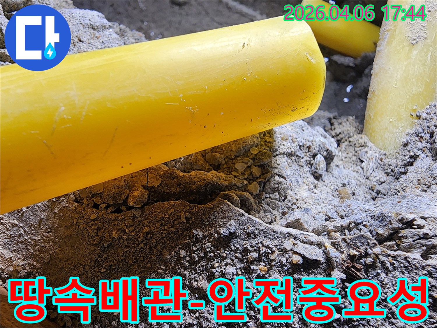 누수 공사 현장에서-땅을 파던 중-드러난 노란색 배관을-안전하게 보호하며-작업하는 모습입니다