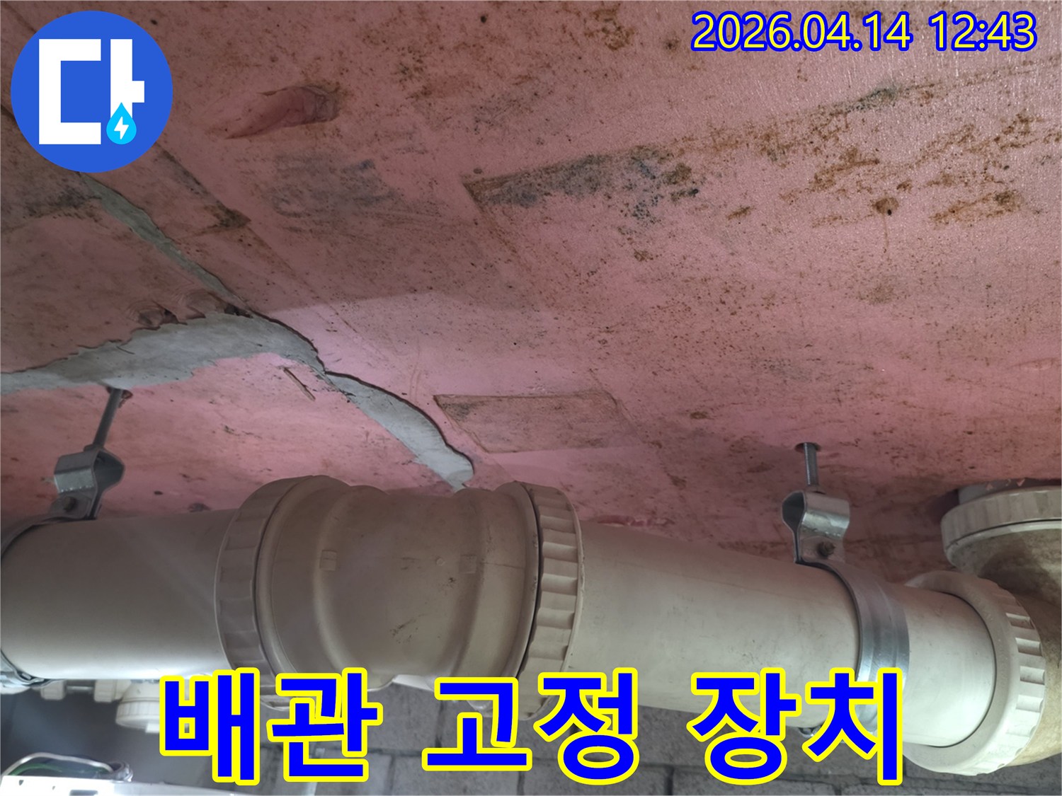 오래된 배관의 연결 부위에서-발생한 누수로 인한-천장 손상을 보여주는-현장 사진입니다.