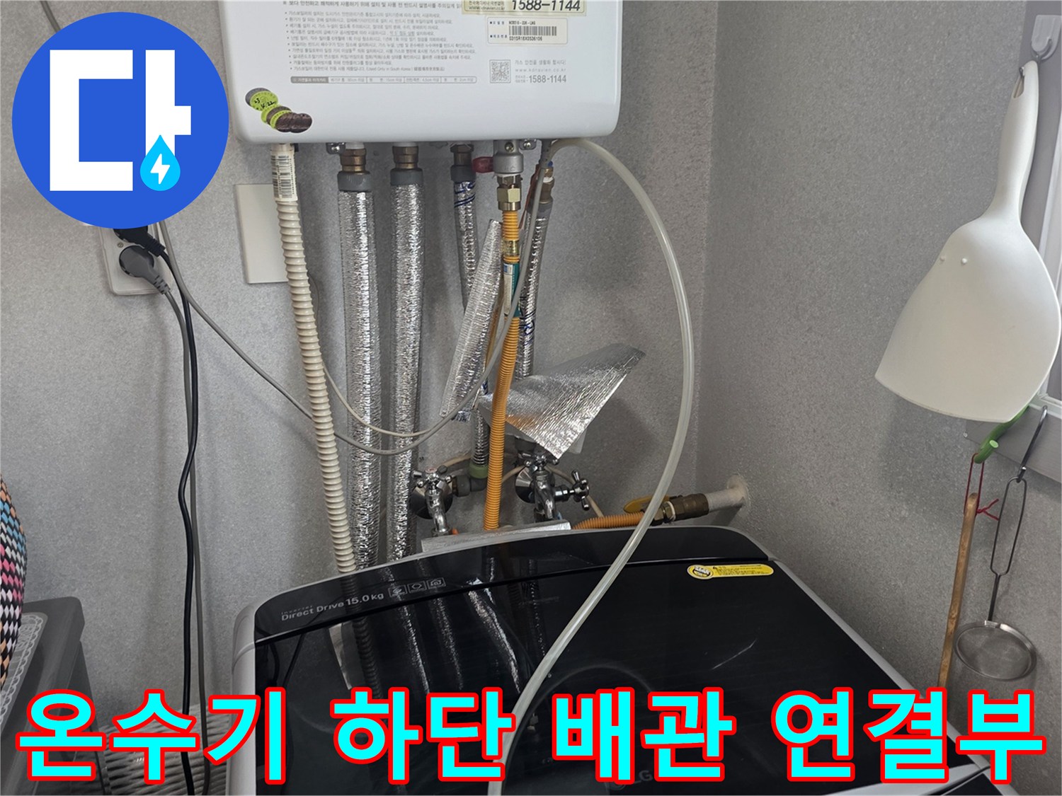 온수기 아래쪽으로 연결된 급수 호스 및 배관