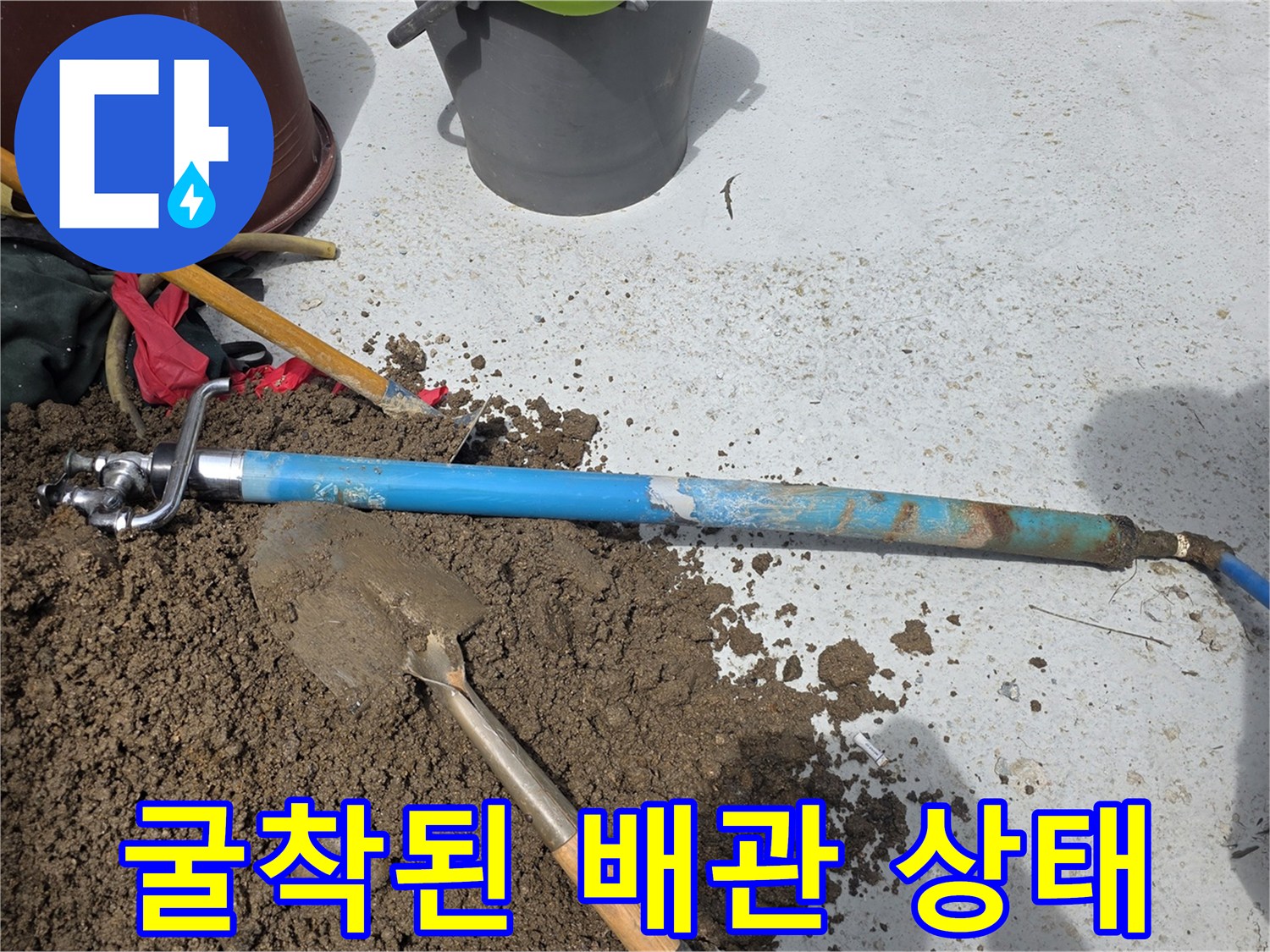 마당 흙을 파낸 곳에 드러난 파란색 수도 배관의 모습