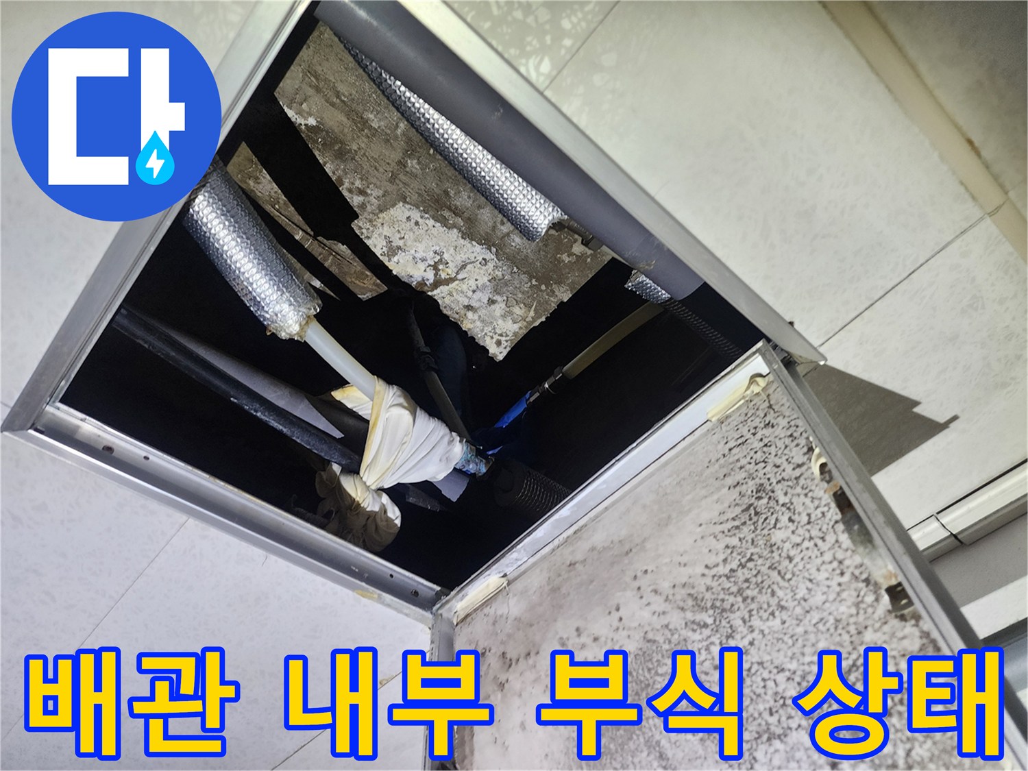 천장 점검구-노후된 배관과 젖은 보온재 모습