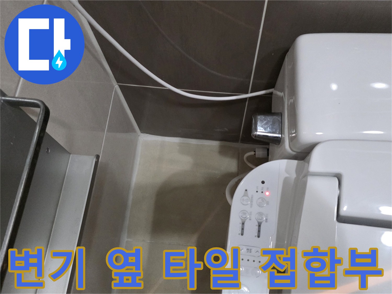양변기 측면 배관 연결부와 벽체 타일 면