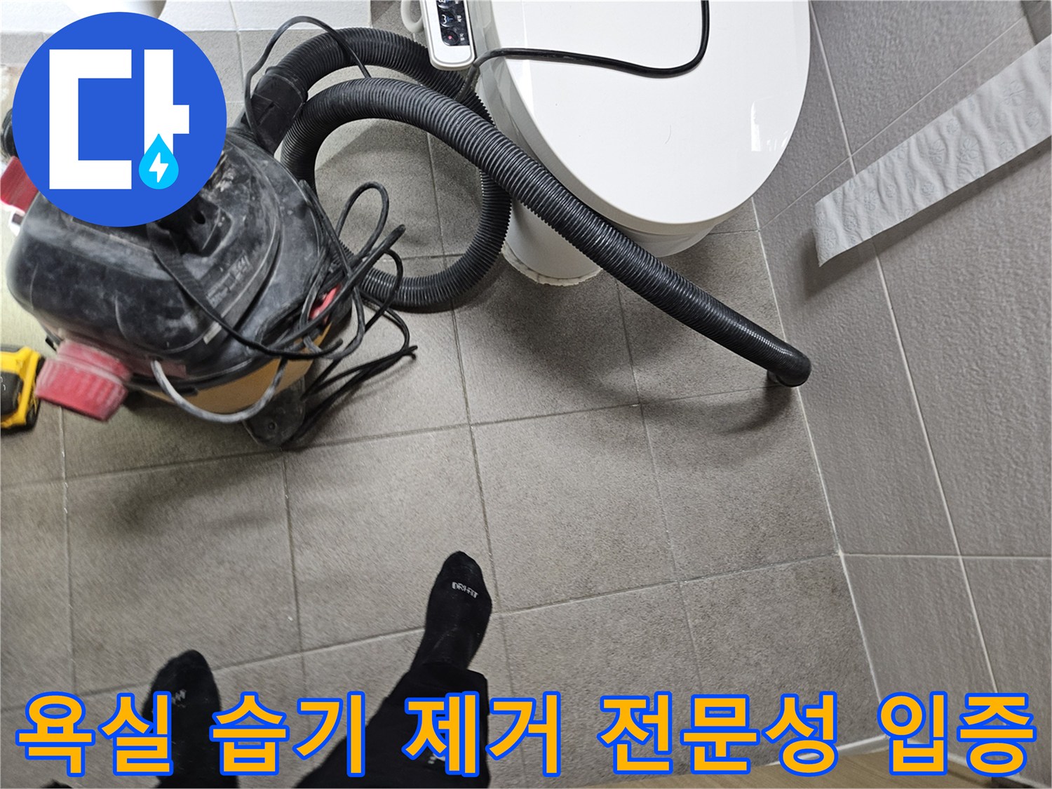 오산시 고객 댁 욕실에서-누수 엔지니어가-변기 주변의 습기를-습식 청소기로 제거하며-전문성을 입증하는 모습