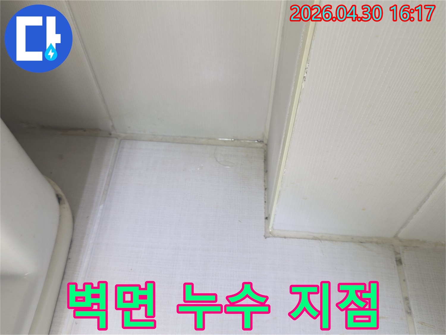 벽과 천장 사이에서 물이 새어 나와-벽면이 축축하게 젖어있는 상태를 보여주는-누수 발생 현장의 증거 사진