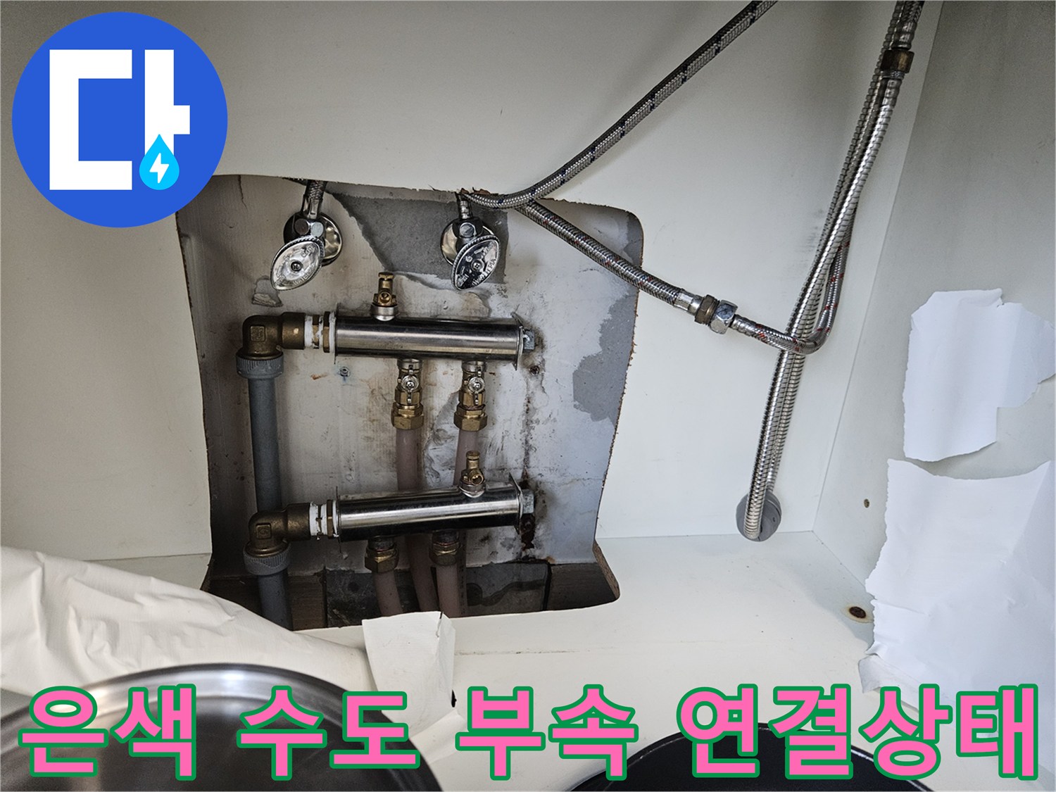 세면대 아래 설치된 은색 금속 소재의 수도 배호스 및 배관