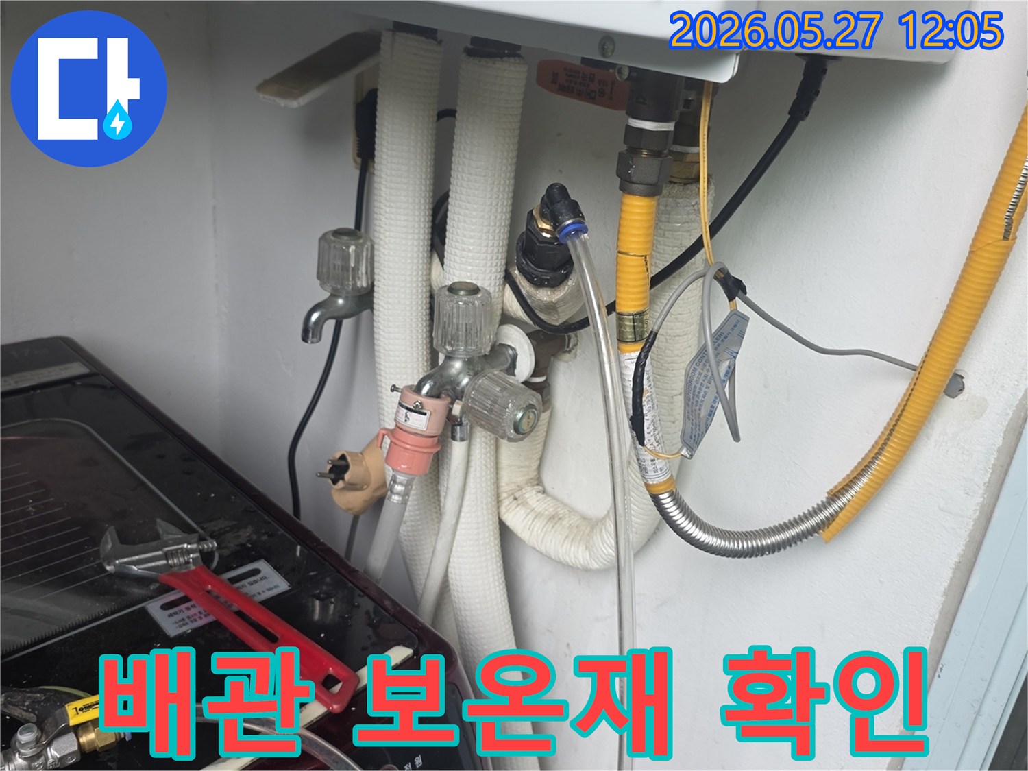 이 사진은-동두천 생연주공 아파트의-배관 보온재 상태를-전문가가-점검하며-누수 징후를-확인하는-모습입니다