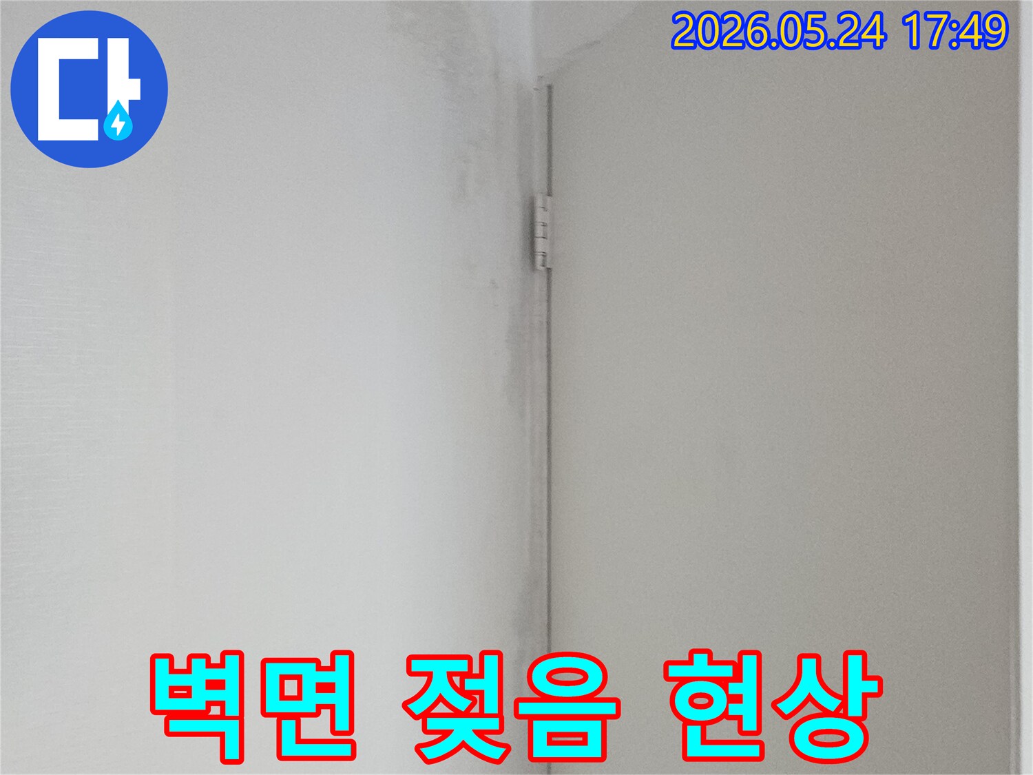 벽과 천장 경계에 물기로 인한 얼룩과 곰팡이가 발생한 상태-누수 피해의 초기 단계입니다.