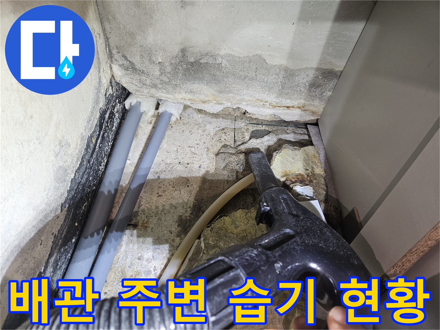 샤워 부스 하단-젖어 있는 배관과 타일 틈새 모습