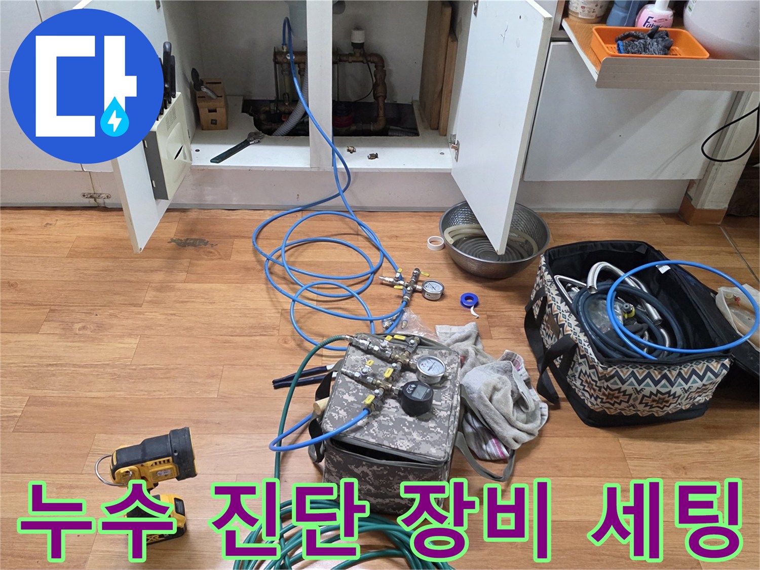 싱크대 하단 공간에 설치된 배관 압력 측정용 게이지와 호스