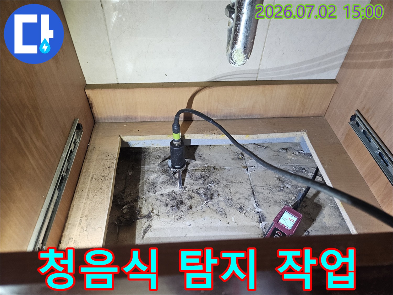 싱크대 하부에서-청음식 누수탐지 장비를-사용하여-배관의-미세한-누수음을-듣고-위치를-파악하는-모습입니다
