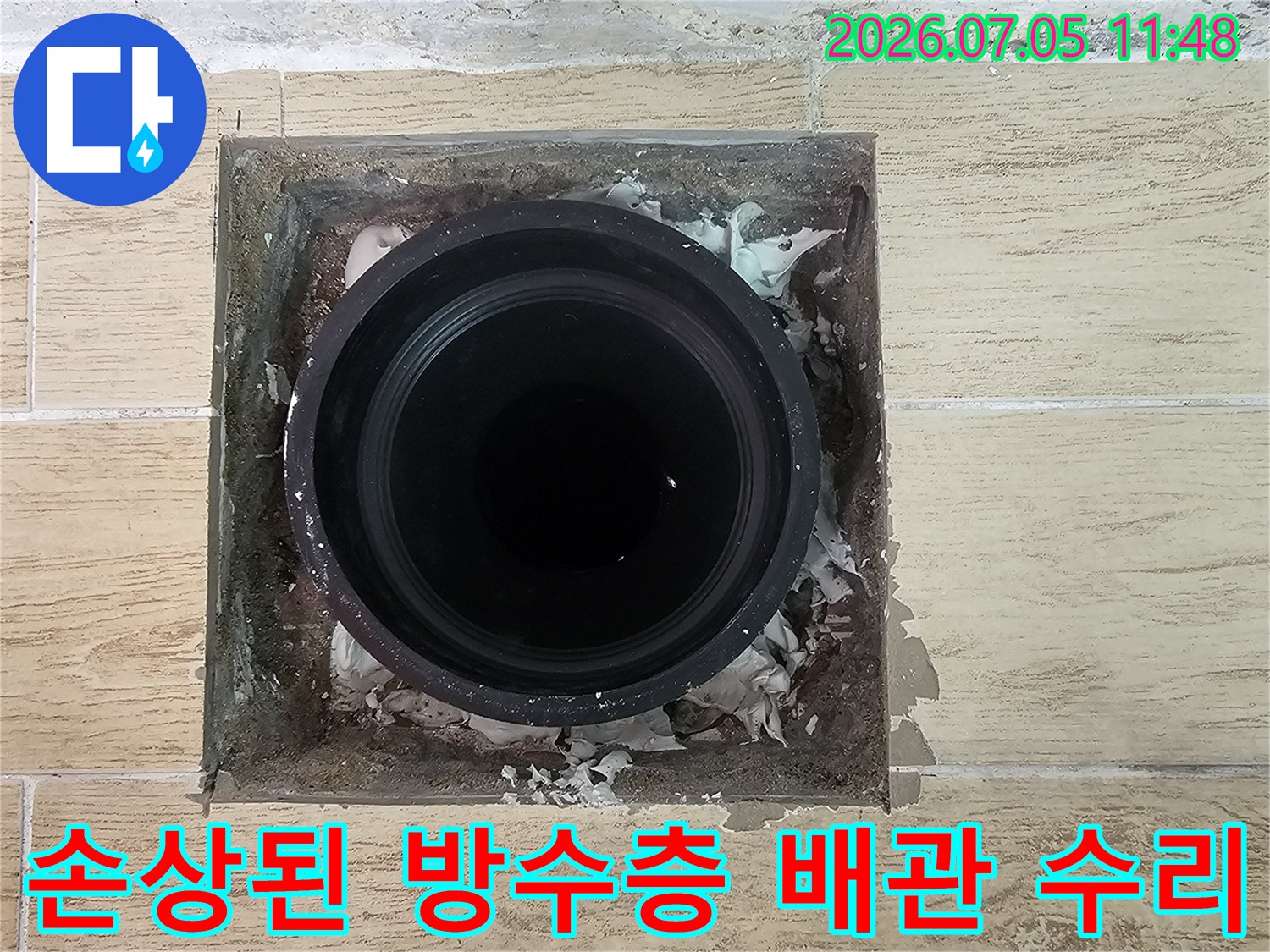 우수관 주변의 부식되고 파손된 마감재와 노출된 배관 구조