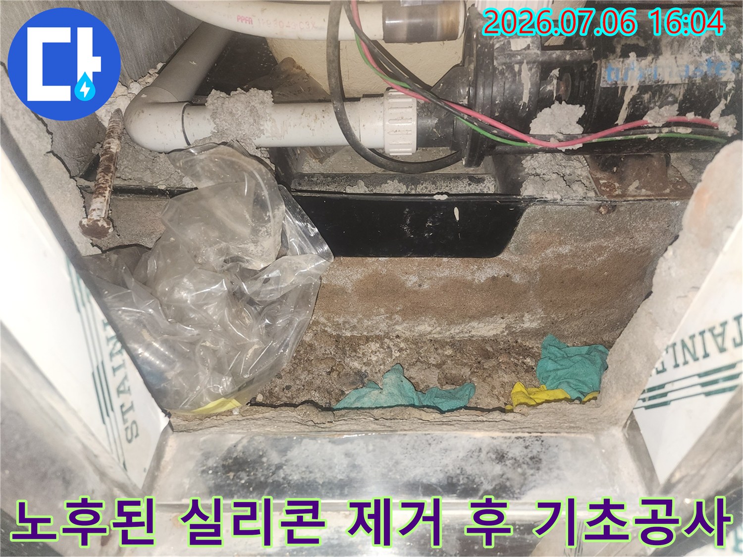 욕조 아래 배관 주변의 지저분한 자재를 제거하고 청소한 상태의 작업 현장