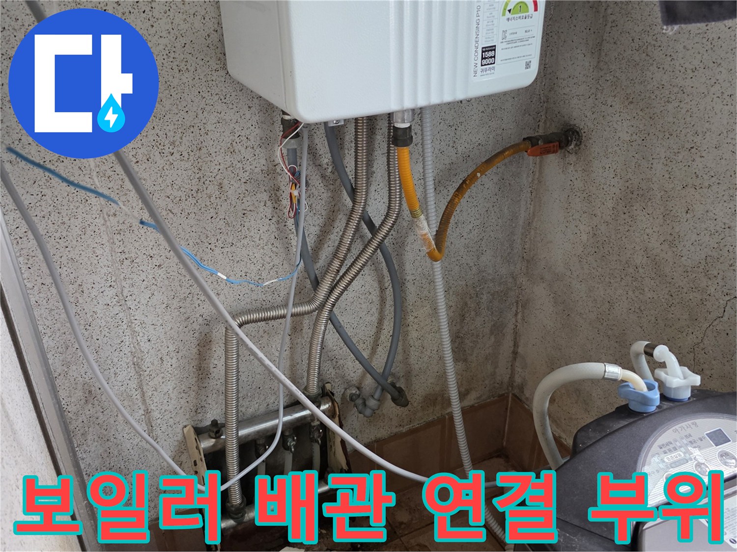 보일러 하단에 연결된 여러 종류의 배관 및 세탁기 호스