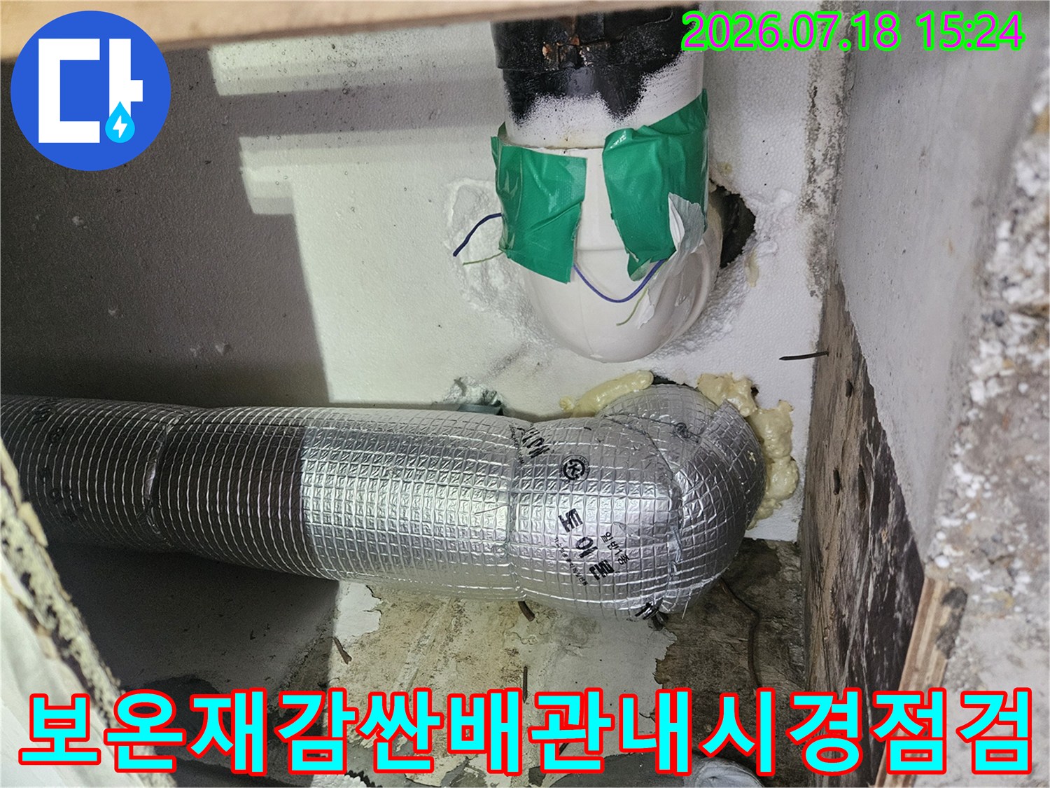 보온재로 감싸진 배관과 상부 수직 배관이 노출된 피트 공간의 점검 모습