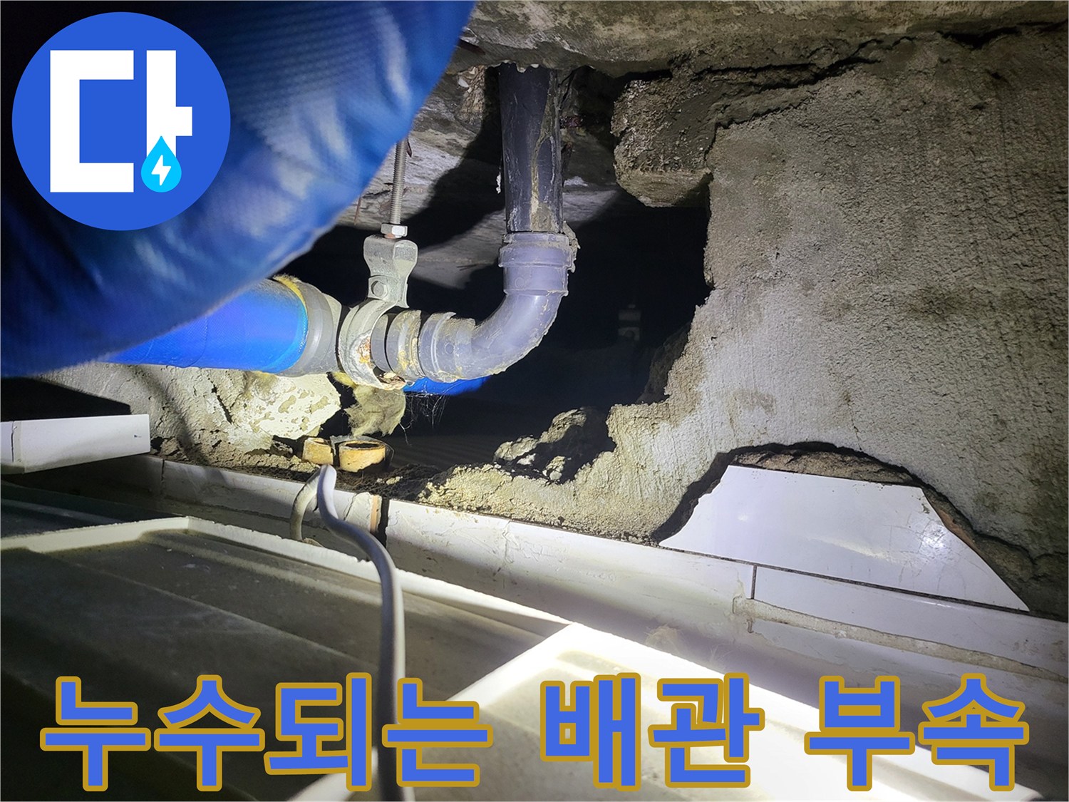 배관 연결 부위의 결함으로 인해 물이 새어 나오는 현장 사진