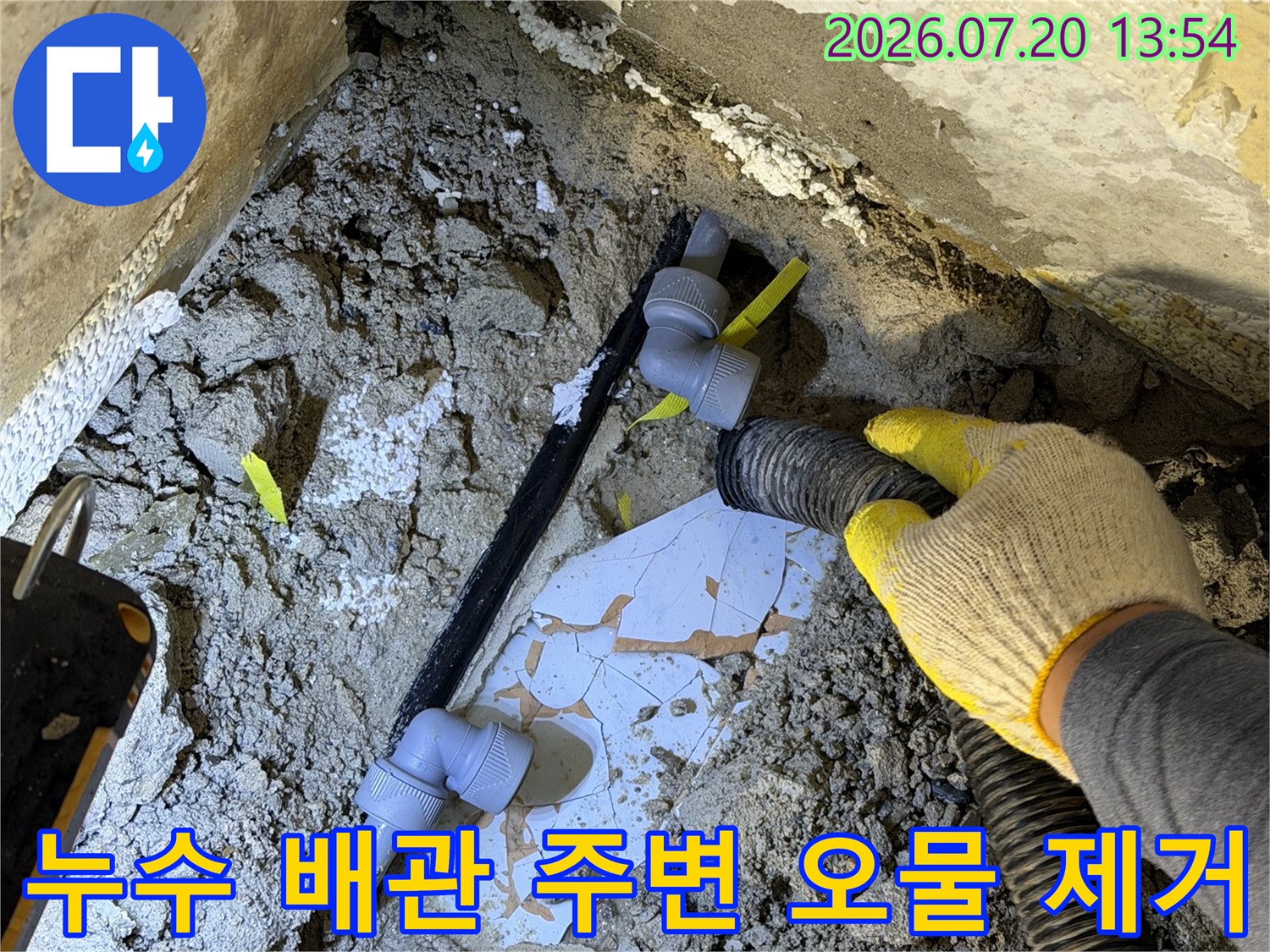 작업자가-강력-흡입기를-사용해-파손된-배관-주변의-흙과-물을-제거하는-모습