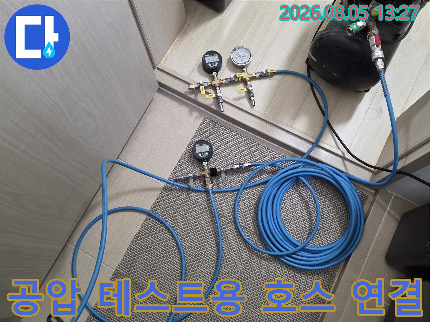파란색 호스와 계측기를 활용한 배관 공압 압력 측정 장면