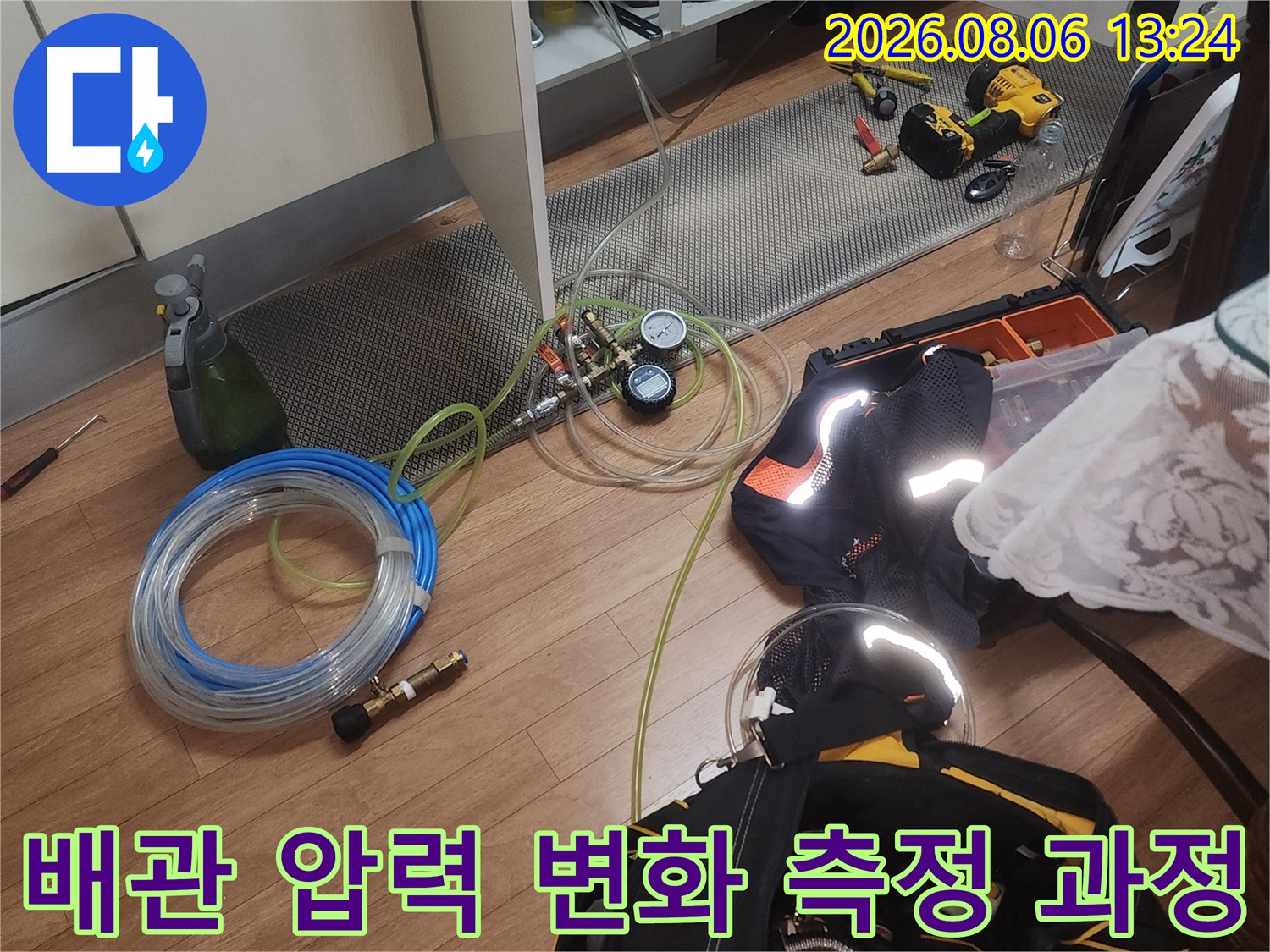 공압 검사 장치와 배관 연결 호스를 통해 시스템의 누수 여부를 점검하는 사진