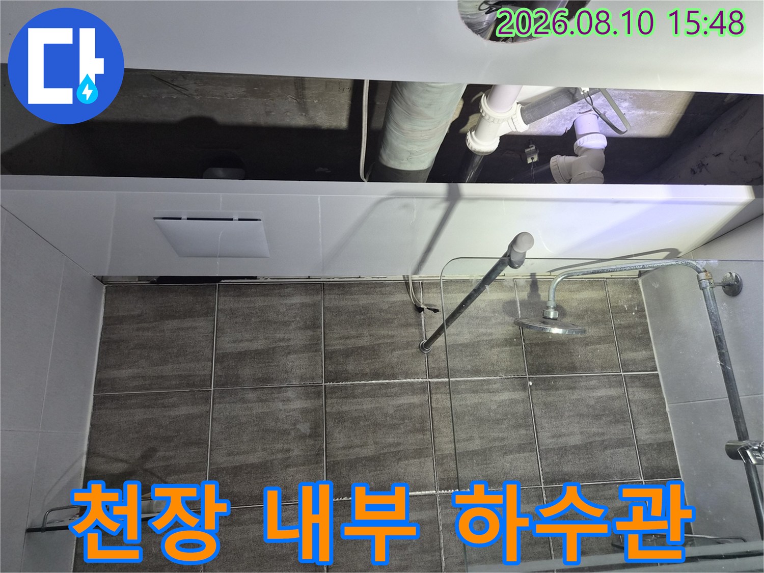 하수 배관과 샤워기 수전이 설치된-욕실 천장 내부의 모습입니다.
