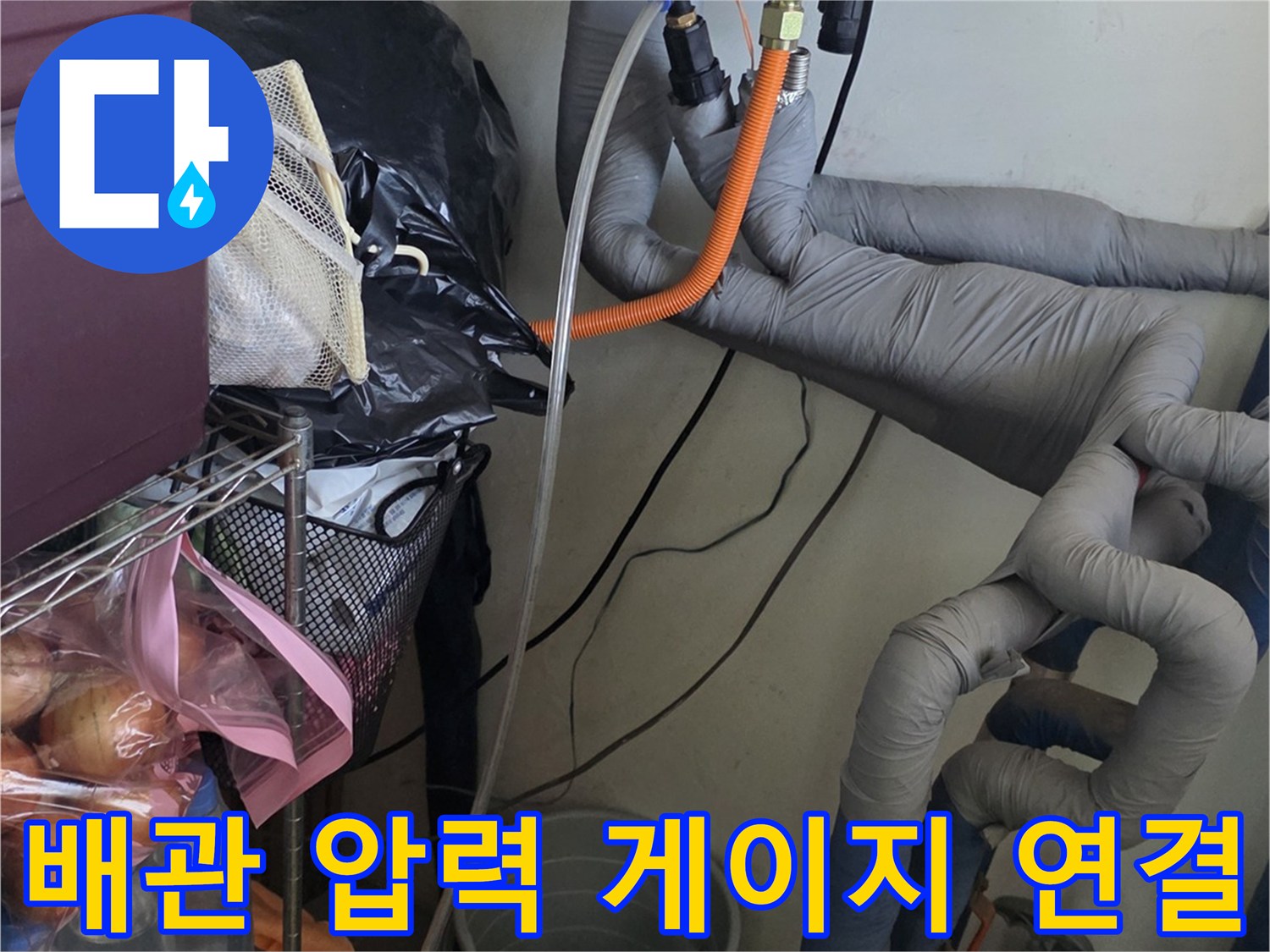 보일러 하단 배관 부위에 압력 전달을 위해 설치된 호스 - 누수 진단 중