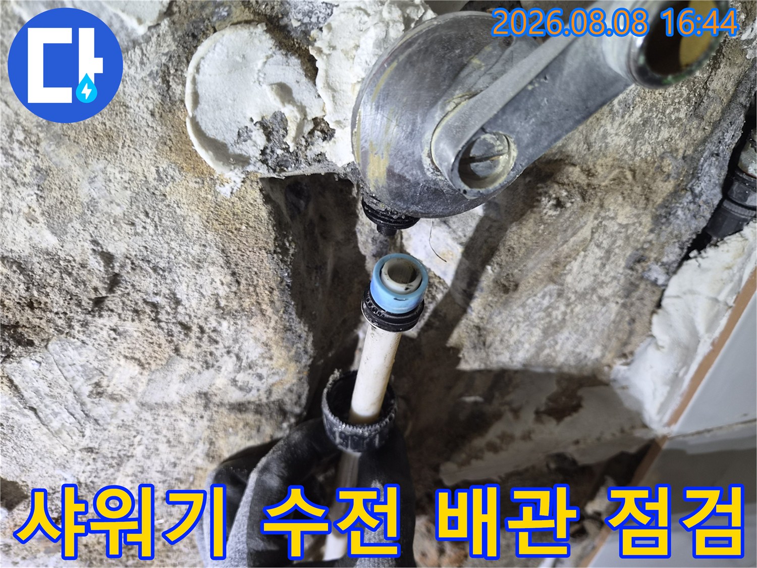 수전과 배관이 연결된 부위의 누수 여부를 세밀하게 관찰하는 모습입니다.