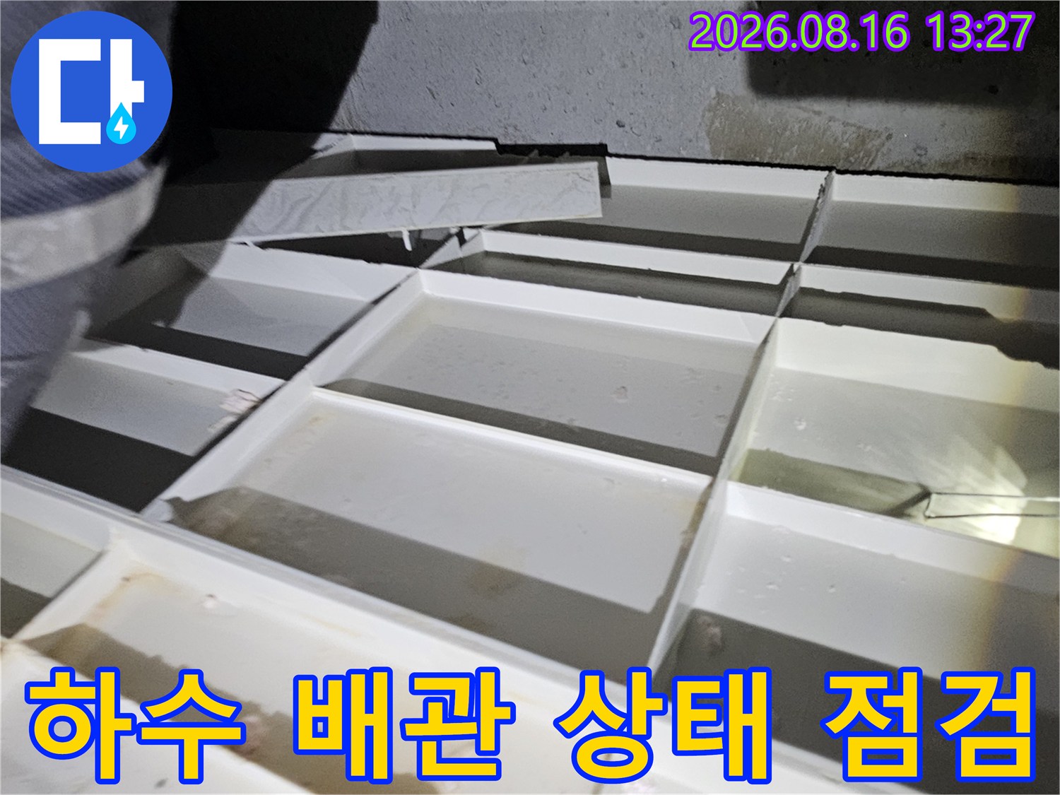 천장 내부의-하수 배관과 연결 부위를 면밀히 관찰하는 중입니다.
