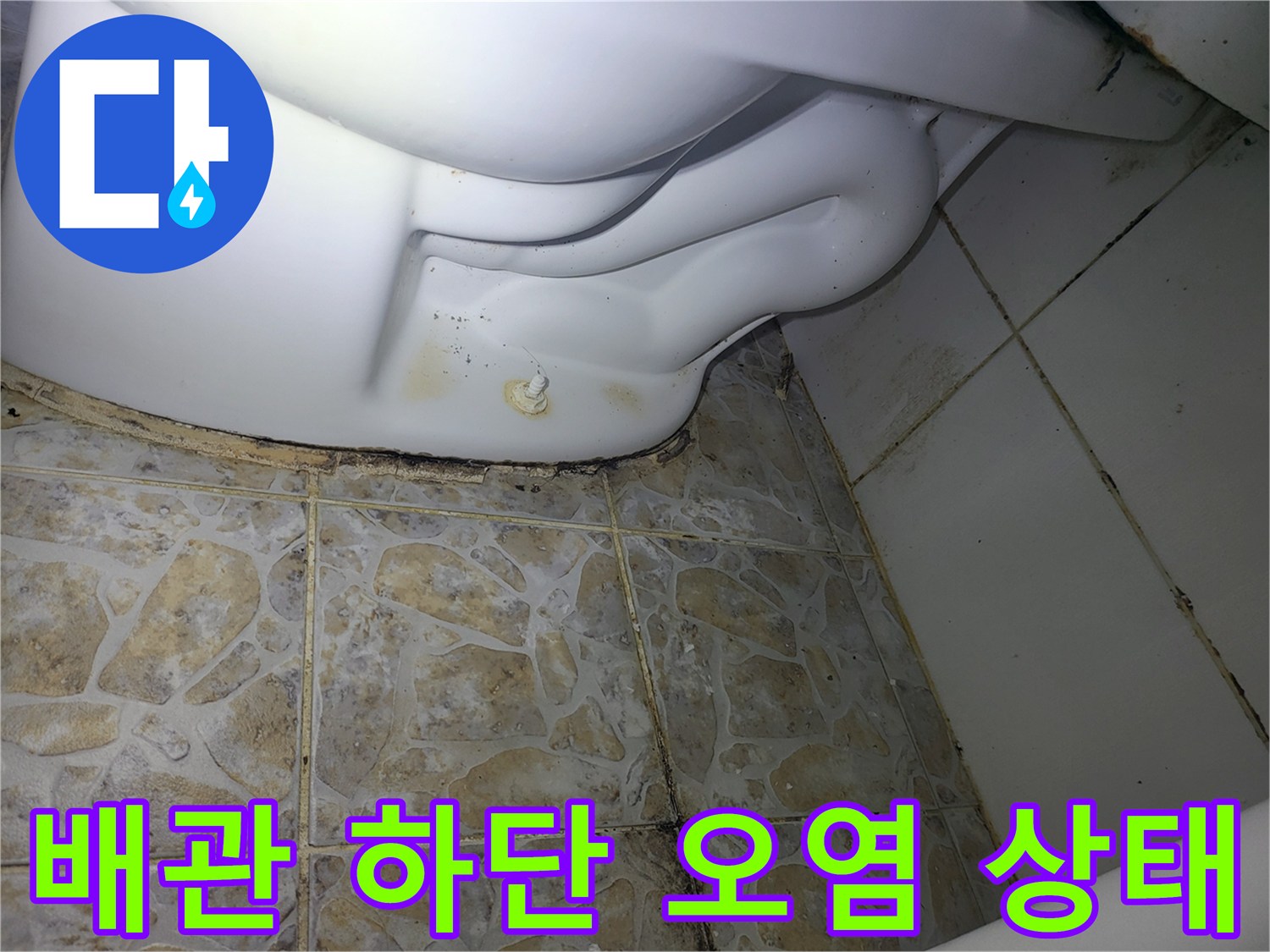 세탁기 연결 배관 아래쪽 타일 틈새의 습기 흔적을 촬영한 사진입니다.