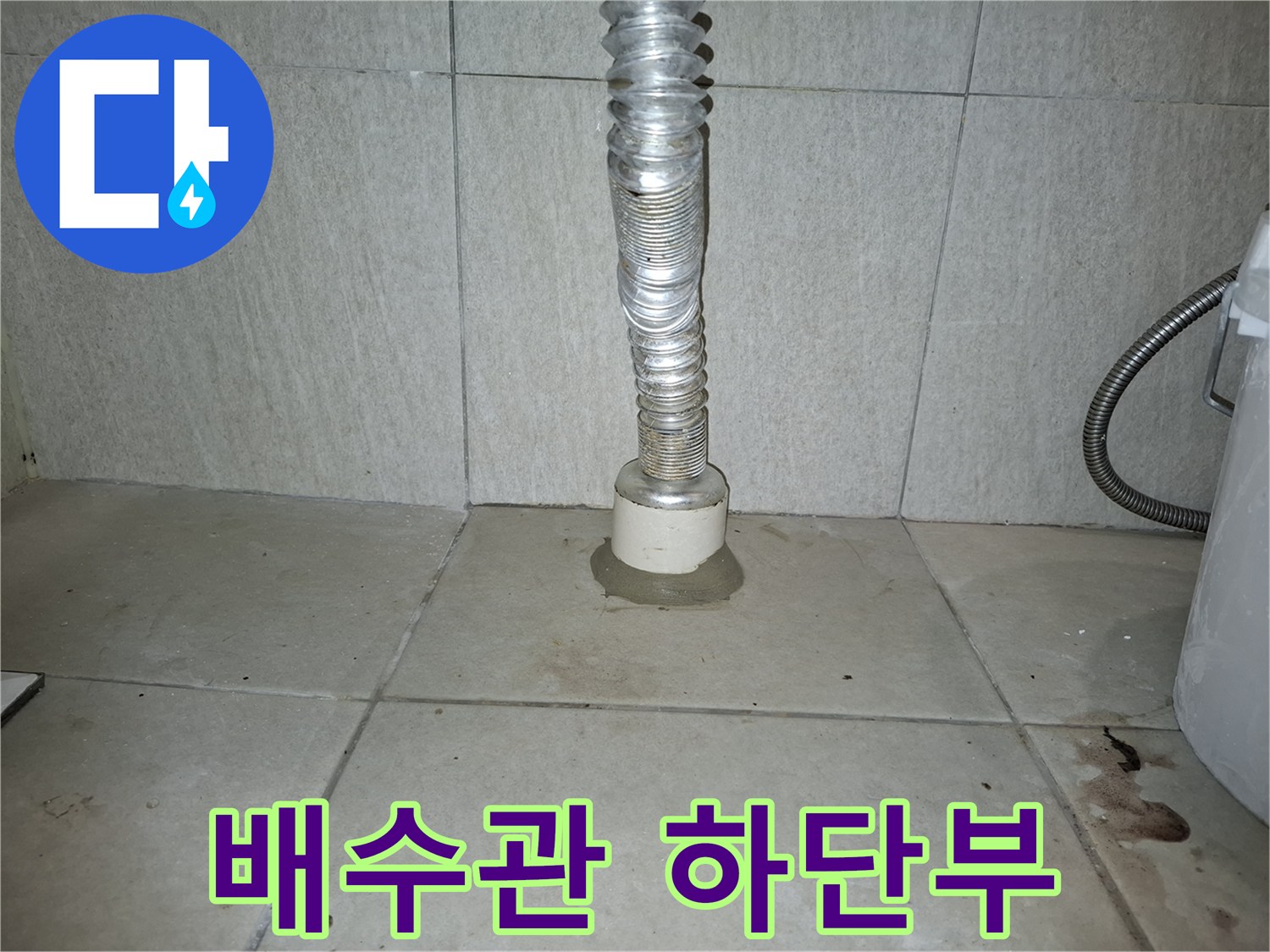 세탁실 주름 배관과 바닥 타일 접합면의 노후 상태 사진