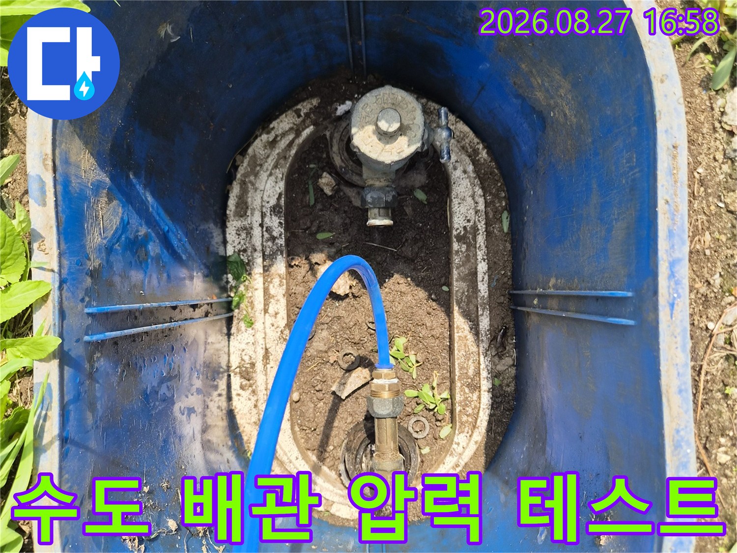 파란색 호스가 연결된 수도 계량기 부속의 모습