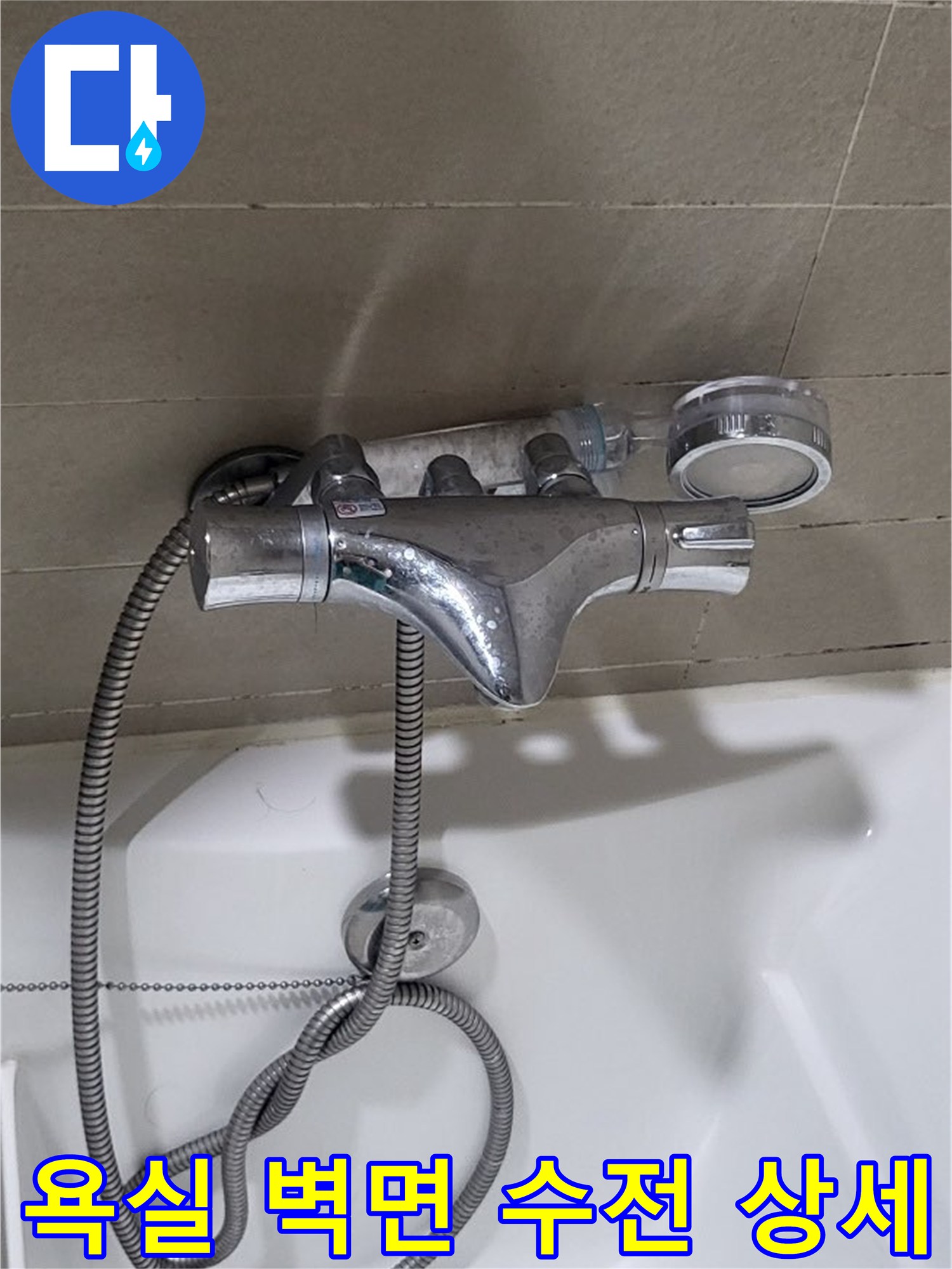 벽면에 설치된 크롬 수전과 샤워기 호스 연결 상태