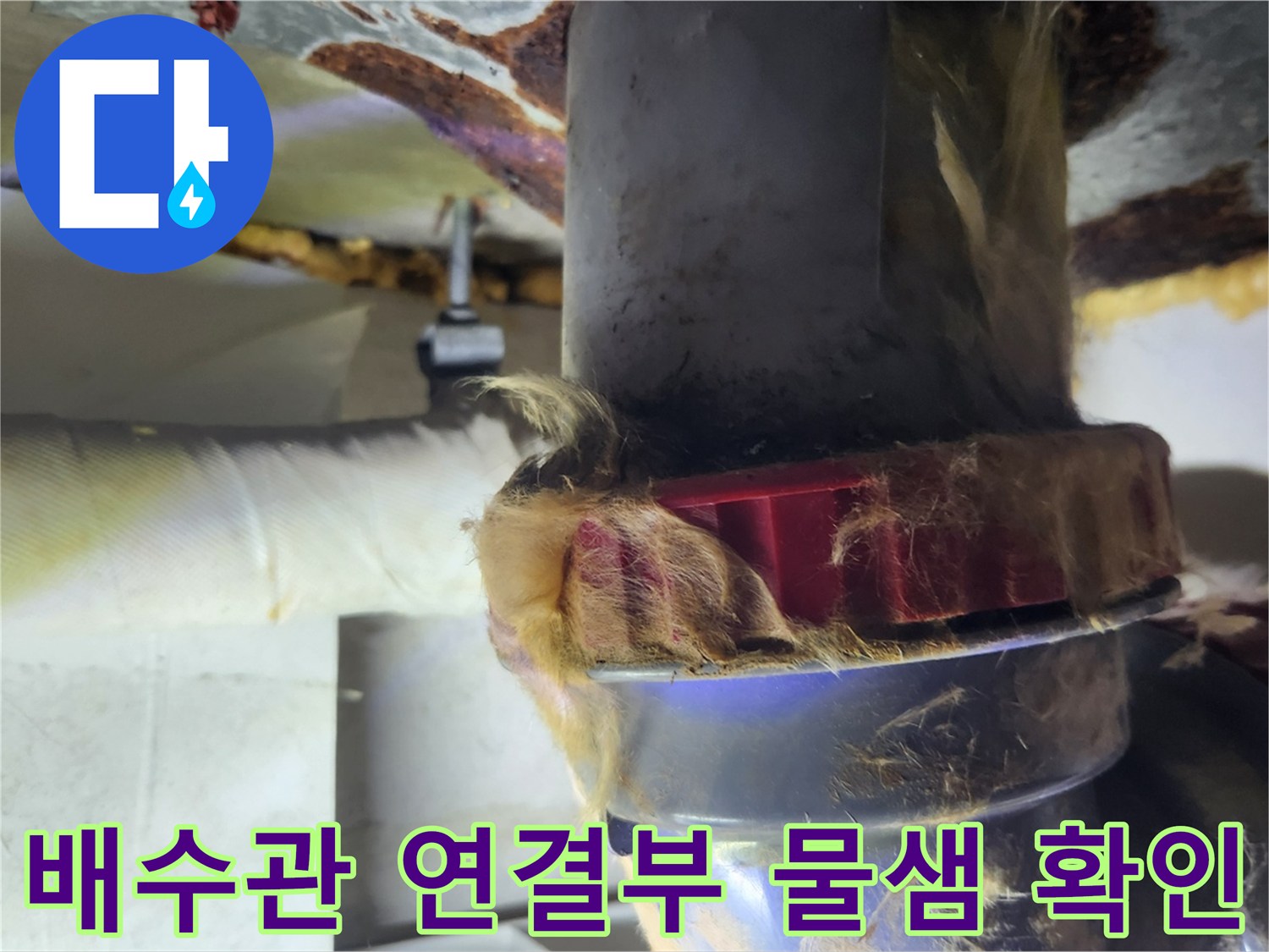 누수가 진행 중인 욕실 배수관의 젖은 연결 부위 모습입니다.