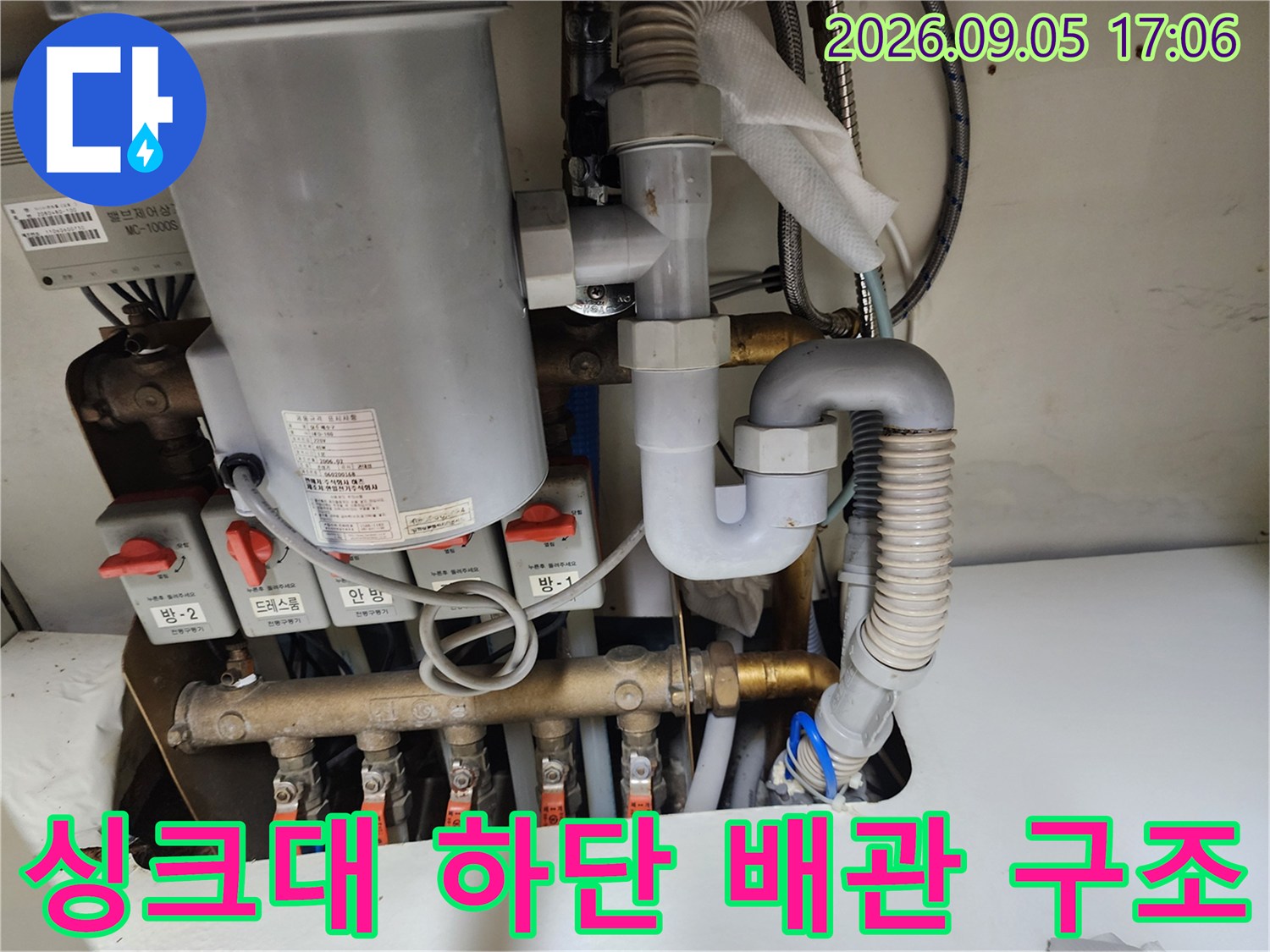 싱크대 하부에 설치된 급수 밸브와 각종 배관 연결 부위