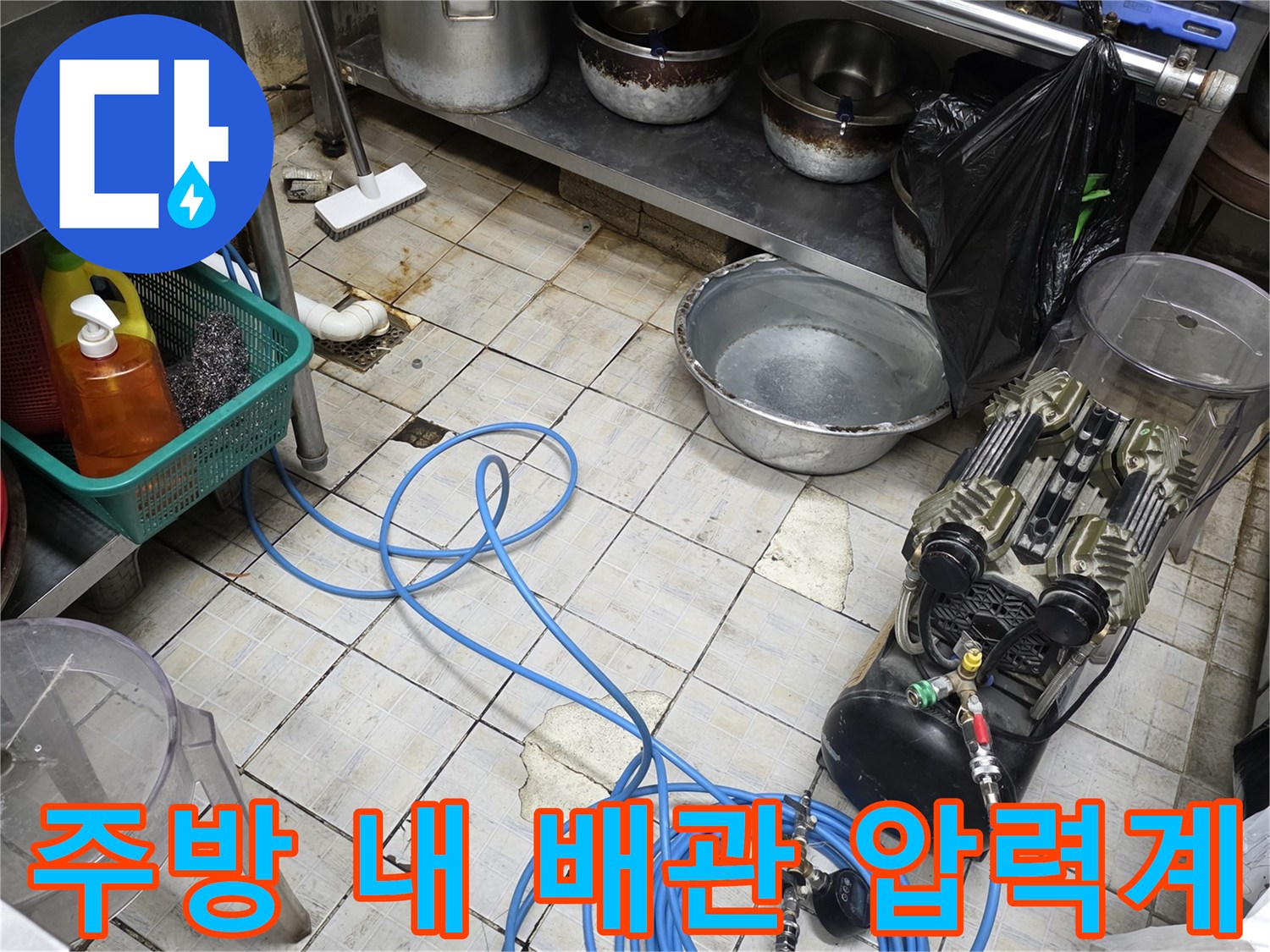 식당 주방 작업 공간에 설치된 배관 압력 측정 장치와 호스
